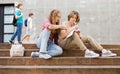 Teenage boy and girl sitting on steps near school Royalty Free Stock Photo