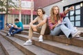Teenage boy and girl sitting on steps near school Royalty Free Stock Photo