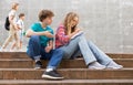 Teenage boy and girl sitting on steps near school Royalty Free Stock Photo