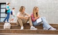 Teenage boy and girl sitting on steps near school Royalty Free Stock Photo