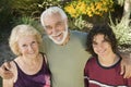 Teenage boy (13-15) with grandparents outdoors elevated view portrait.