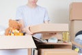 Teenage boy hands holding blank cardboard box. Volunteer collecting food into donation box. Donation, charity, food bank Royalty Free Stock Photo