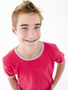 Teenage boy with hands in pockets smiling Royalty Free Stock Photo