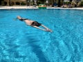 Teenage boy having joy in blue water of swimming pool Royalty Free Stock Photo