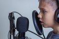 Teenage boy with headphones using microphone. Online learning, remote education, video game, podcast concept Royalty Free Stock Photo