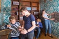 Two teen brothers examining ancient kettle in quest room Royalty Free Stock Photo