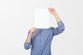 Teenage boy holding blank sheet of paper infront of his face. Man covering face with blank sheet of paper for hiding his identity Royalty Free Stock Photo