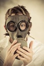 Teenage boy holding gas mask on face Royalty Free Stock Photo