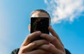 Teenage boy holding hes smartphone, focus on the boys hand Royalty Free Stock Photo