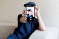 teenage boy holding a smart phone in front of his face at home, taking selfies with his smartphone, digital display on Royalty Free Stock Photo