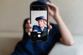 teenage boy holding a smart phone in front of his face at home, taking selfies with his smartphone, digital display on Royalty Free Stock Photo