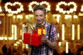 Teenage boy holding stack of gift boxes. Royalty Free Stock Photo