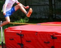 Teenage boy jumping over a high jump bar like he is hurdling Royalty Free Stock Photo
