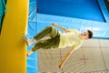 Teenage boy jumping on trampoline park in sport center