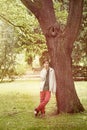 Teenage boy leaning against a tree Royalty Free Stock Photo