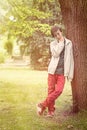 Teenage boy leaning against a tree Royalty Free Stock Photo