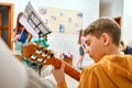 A teenage boy learns to play the guitar and looks at the notes Royalty Free Stock Photo