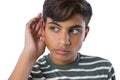 Teenage boy listening secretly with hands behind her ears