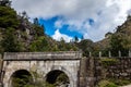 Teenage boy looks at bridge. Small mountain bridge over a creek from the Peneda Geres National Park, north of Portugal Royalty Free Stock Photo