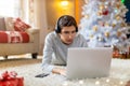 Teenage boy using laptop at home in Christmas time Royalty Free Stock Photo