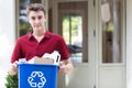 Portrait Of Teenage Boy Outside House Carrying Recycling Bin Royalty Free Stock Photo