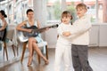 Boy and girl in pair train to dance tango during classes with accompaniment of guitar