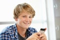 Teenage boy with phone in class Royalty Free Stock Photo