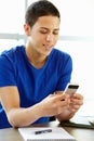 Teenage boy with phone in class Royalty Free Stock Photo