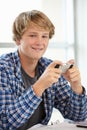 Teenage boy with phone in class Royalty Free Stock Photo