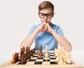 Teenage Boy Playing Chess Game. Kid Learning Strategy Thinking. Child Education Concept over White Studio background Royalty Free Stock Photo