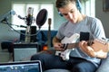 Teenage Boy Playing Guitar And Recording Music At Home Royalty Free Stock Photo