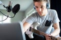 Teenage Boy Playing Guitar And Recording Music Onto Laptop At Home Royalty Free Stock Photo