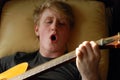 Teenage boy playing guitar and singing Royalty Free Stock Photo