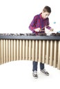 Teenage boy playing marimba in studio