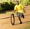 Teenage Boy Playing with Tyre - Yellow T-Shirt Royalty Free Stock Photo