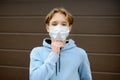 A teenage boy put on a face mask because the second wave of the covid-19 epidemic began. Lockdown. The mask is the new standard