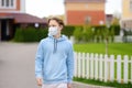 Teenage boy put on face mask because the second wave of covid-19 epidemic began. Lockdown. Mask is new standard for protection and