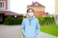 Teenage boy put on face mask because the second wave of covid-19 epidemic began. Lockdown. Mask is new standard for protection and