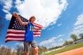 Teenage boy, race winner, running with flag of USA Royalty Free Stock Photo