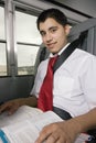 Teenage Boy Reading Textbook In Bus