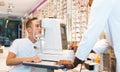 Teenage boy receiving eye examination on modern refractometer in optical store with professional African-American Royalty Free Stock Photo