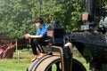 Teenage Boy Sat on a Vintage Road Roller. Royalty Free Stock Photo