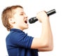 Teenage boy singing into a microphone. Very emotional Royalty Free Stock Photo