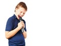 Teenage boy singing into a microphone. Very emotional. Royalty Free Stock Photo