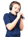 Teenage boy singing into a microphone. Very emotional. Royalty Free Stock Photo