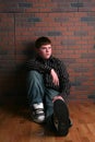 Teenage boy sitting on floor