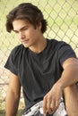 Teenage Boy Sitting In Playground Royalty Free Stock Photo