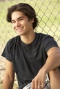 Teenage Boy Sitting In Playground Royalty Free Stock Photo