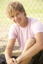 Teenage Boy Sitting In Playground Royalty Free Stock Photo