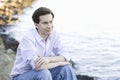 Teenage Boy Sitting by Water Royalty Free Stock Photo